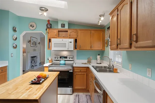 a kitchen with stainless steel appliances a refrigerator and cabinets