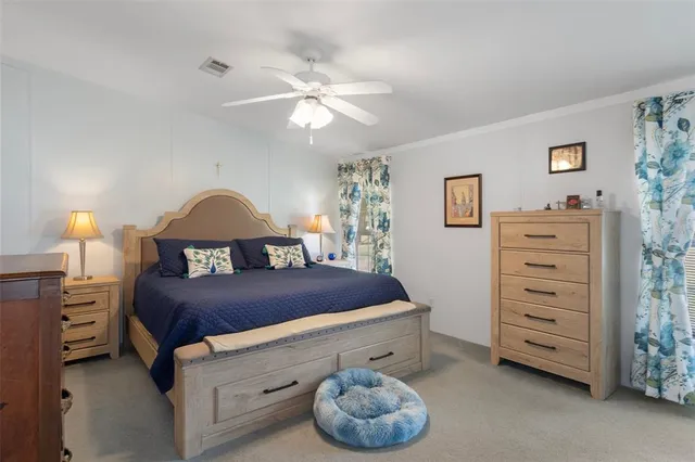 a spacious bedroom with a bed and a chandelier