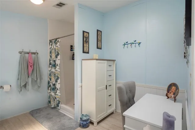 a bathroom with a sink a toilet and shower curtain