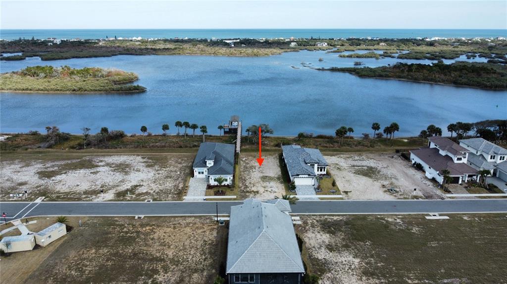 84 Coronado Road Flagler Beach, FL 32136 - Photo 1 of 15 an aerial view of a house with a lake view