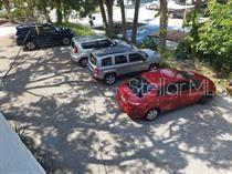 318 East Tarpon Avenue, Unit 5 Tarpon Springs, FL 34689 - Photo 16 of 16 a front view of a house with cars parked