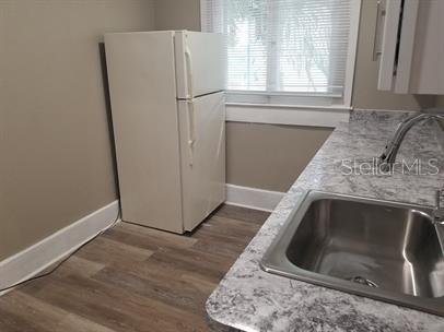 318 East Tarpon Avenue, Unit 5 Tarpon Springs, FL 34689 - Photo 10 of 16 a utility room with wooden floor washer and dryer