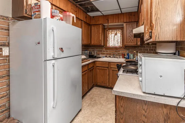 a white refrigerator freezer sitting inside of a kitchen