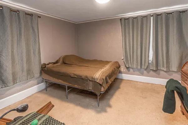 a bed sitting in a room next to a window