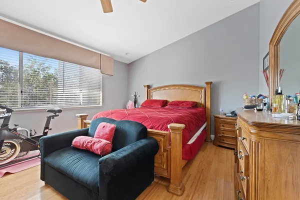 a bedroom with a bed couch and window