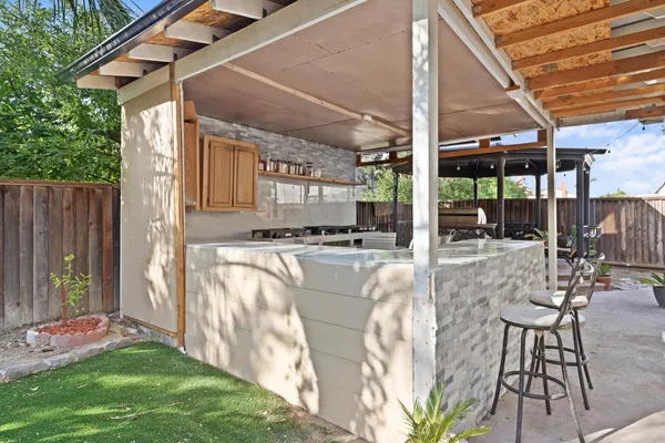 a view of a patio with table and chairs and wooden floor