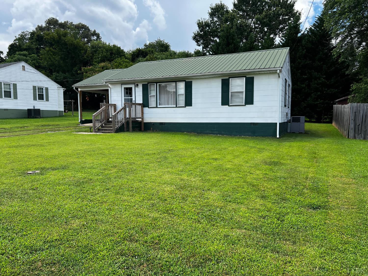 156 Doss Street Altavista, VA 24517 - Photo 3 of 15 a front view of a house with garden