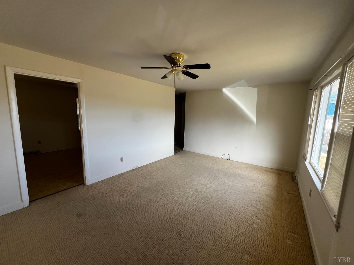 156 Doss Street Altavista, VA 24517 - Photo 6 of 15 an empty room with windows and fan