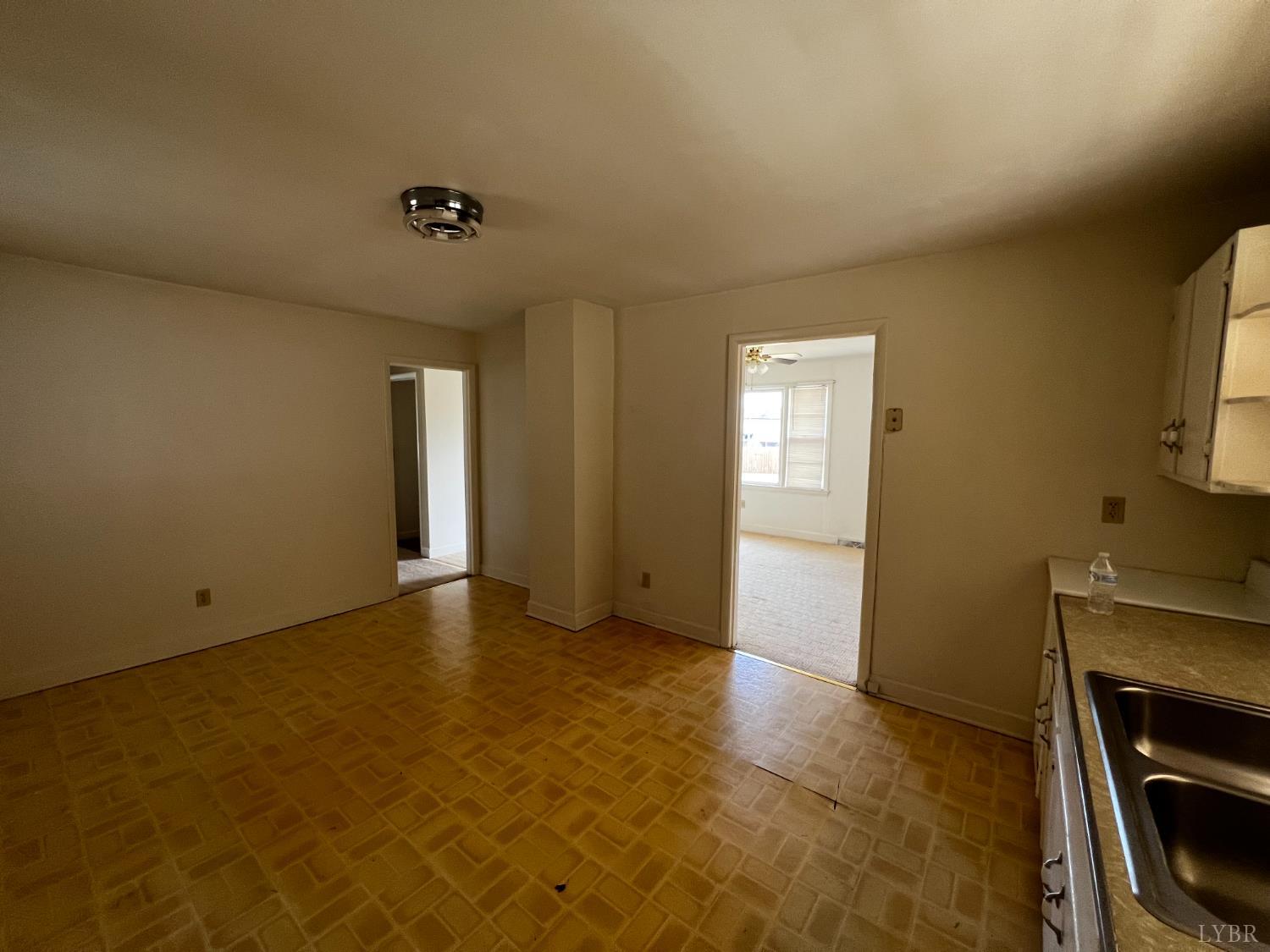 156 Doss Street Altavista, VA 24517 - Photo 8 of 15 a view of an empty room with a fireplace and a window