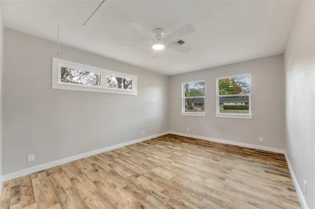 a view of a room with wooden floor and window