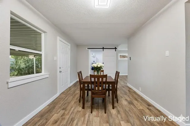 a view of a dining room with furniture and wooden floor
