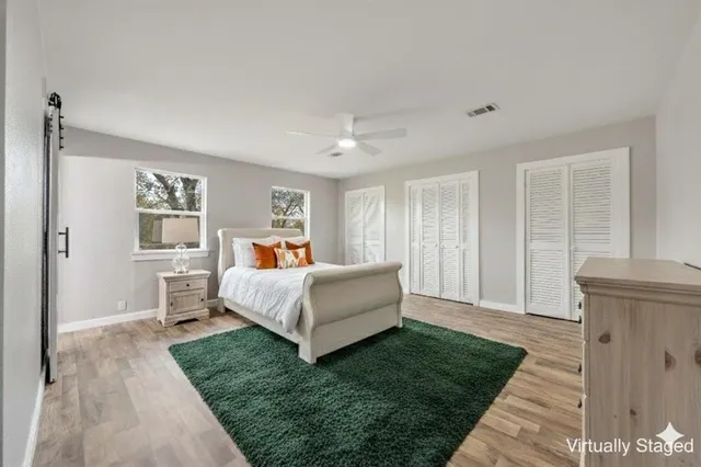 a spacious bedroom with a bed and window