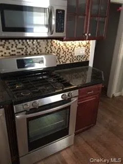a stove top oven sitting inside of a kitchen