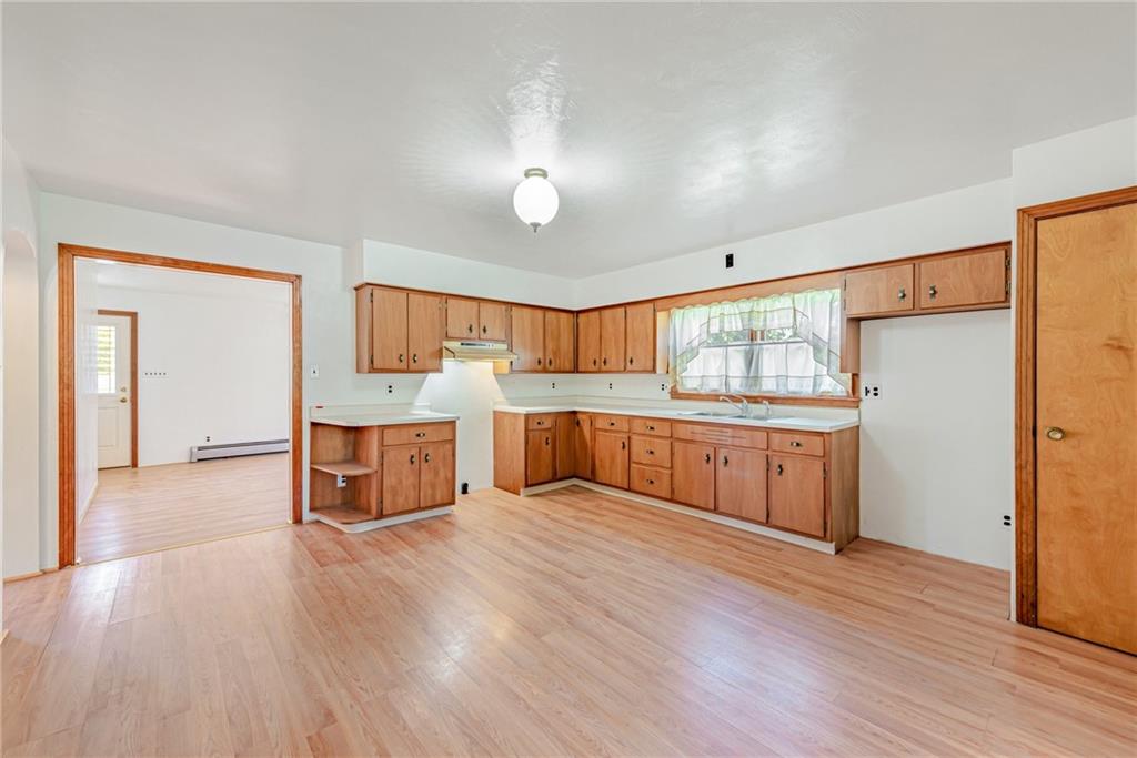 1598 Keystone Park Road New Alexandria, PA 15670 - Photo 9 of 28 a large kitchen with stainless steel appliances granite countertop a large counter top and wooden floors