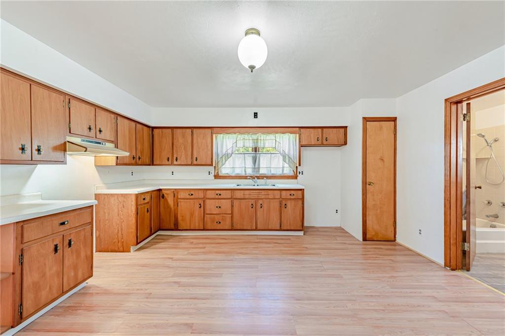 1598 Keystone Park Road New Alexandria, PA 15670 - Photo 10 of 28 a kitchen with stainless steel appliances granite countertop a stove a sink and a refrigerator with wooden floors