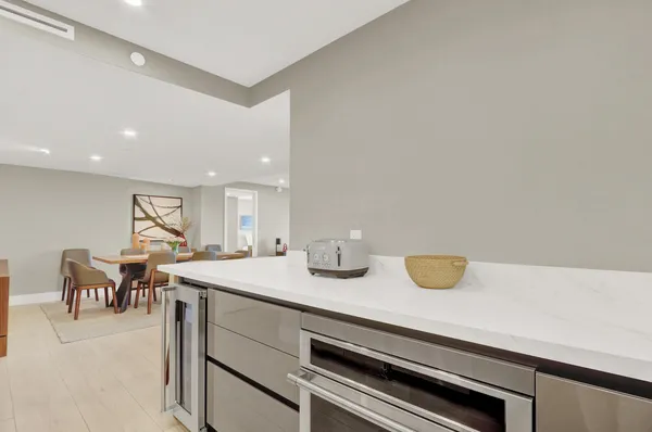 a kitchen with a sink a table and chairs