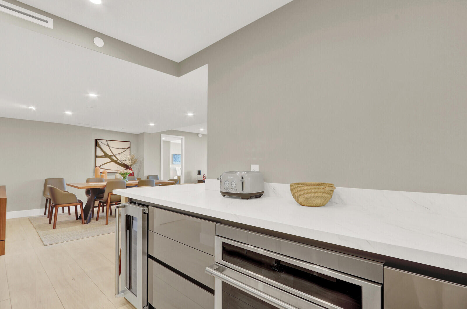 4201 North Ocean Boulevard, Unit C1202 Boca Raton, FL 33431 - Photo 11 of 47 a kitchen with a sink a table and chairs