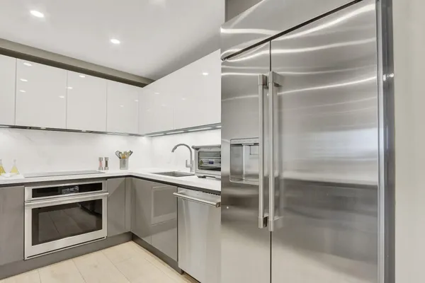 a kitchen with a sink and stainless steel appliances