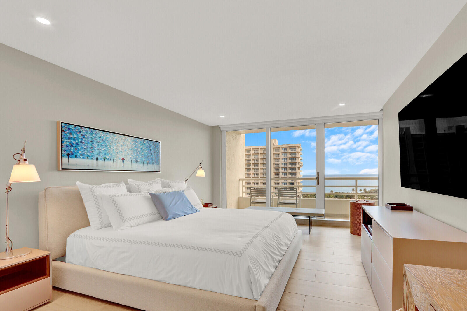 4201 North Ocean Boulevard, Unit C1202 Boca Raton, FL 33431 - Photo 25 of 47 a spacious bedroom with a large bed and a flat screen tv