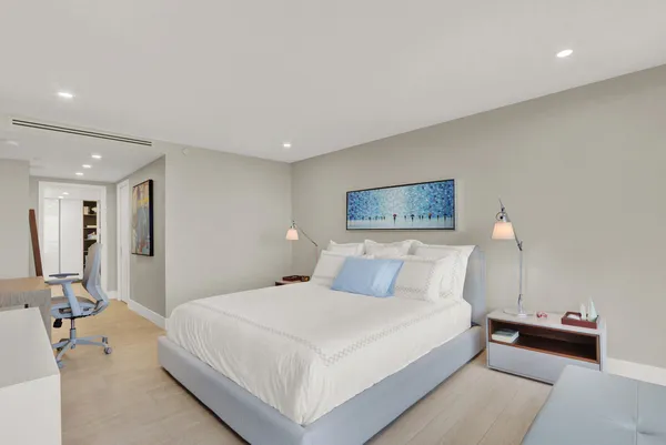 a bedroom with a bed and a lamp