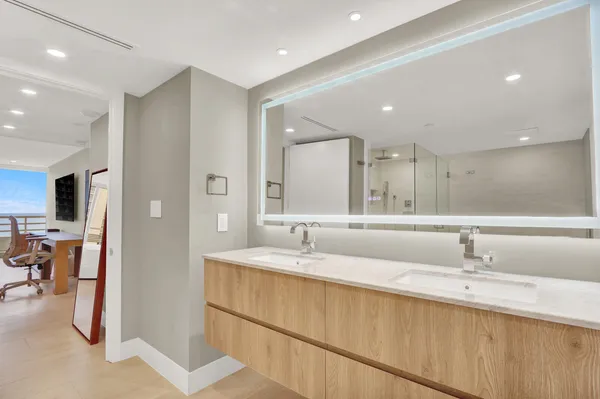 a bathroom with a double vanity sink and a mirror