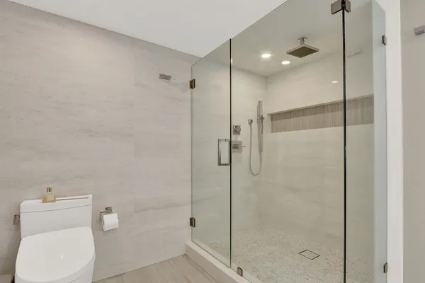 a bathroom with a shower a toilet and a sink