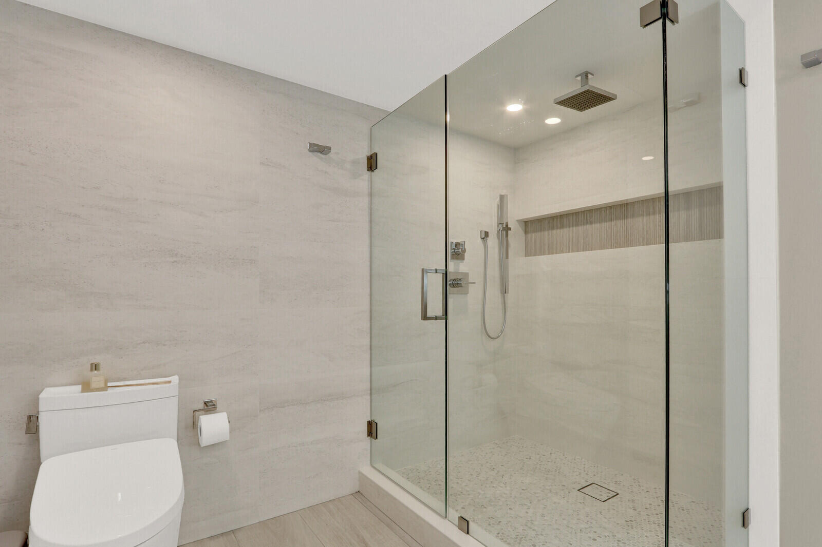 4201 North Ocean Boulevard, Unit C1202 Boca Raton, FL 33431 - Photo 33 of 47 a bathroom with a shower a toilet and a sink