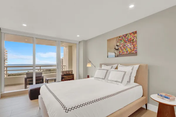a bedroom with a large bed and a large window