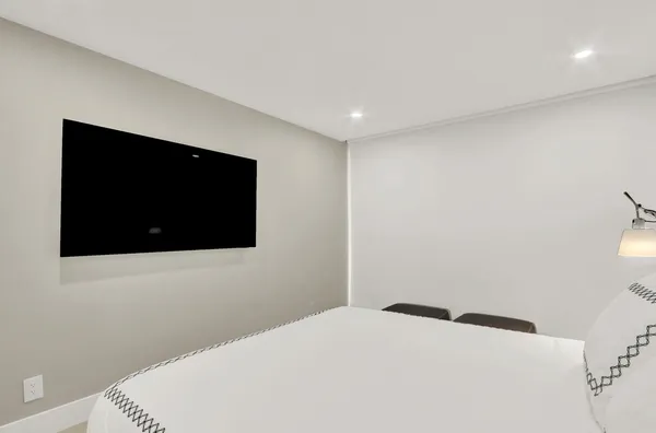 a bedroom with a bed and a flat screen tv