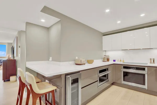 a kitchen that has a sink and a stove in it