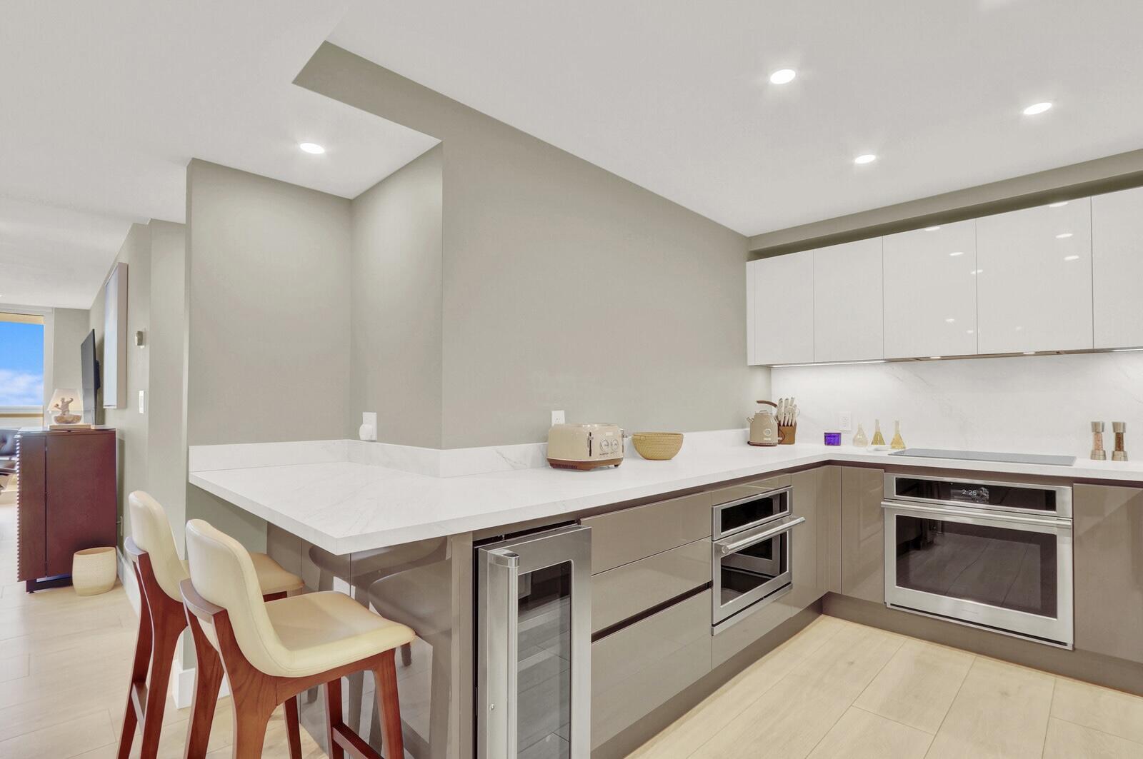 4201 North Ocean Boulevard, Unit C1202 Boca Raton, FL 33431 - Photo 10 of 47 a kitchen that has a sink and a stove in it