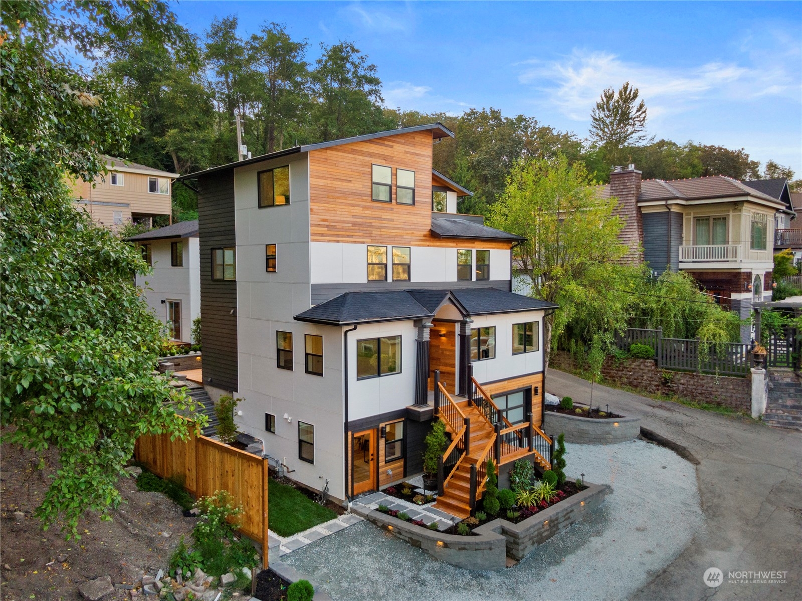 a view of a house with a yard and potted plants