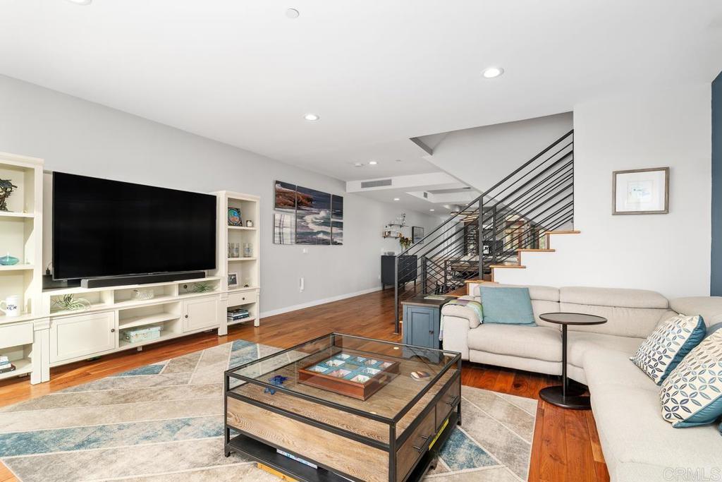 215 2nd Street, Unit 101 Encinitas, CA 92024 - Photo 13 of 47 a living room with furniture and a flat screen tv