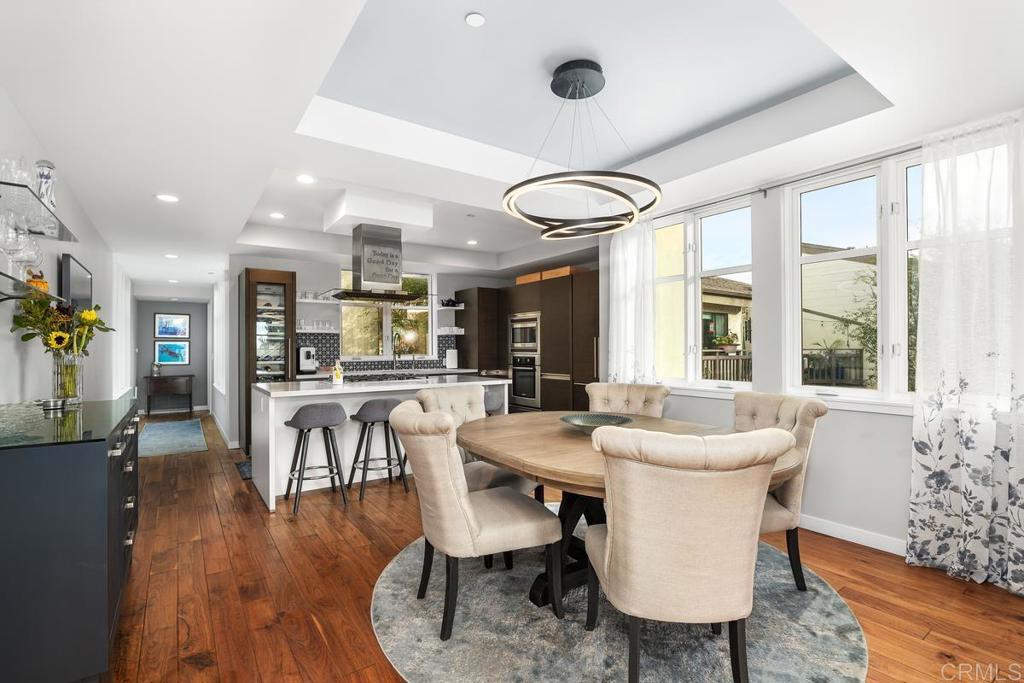 215 2nd Street, Unit 101 Encinitas, CA 92024 - Photo 14 of 47 a dining room with furniture a window and wooden floor