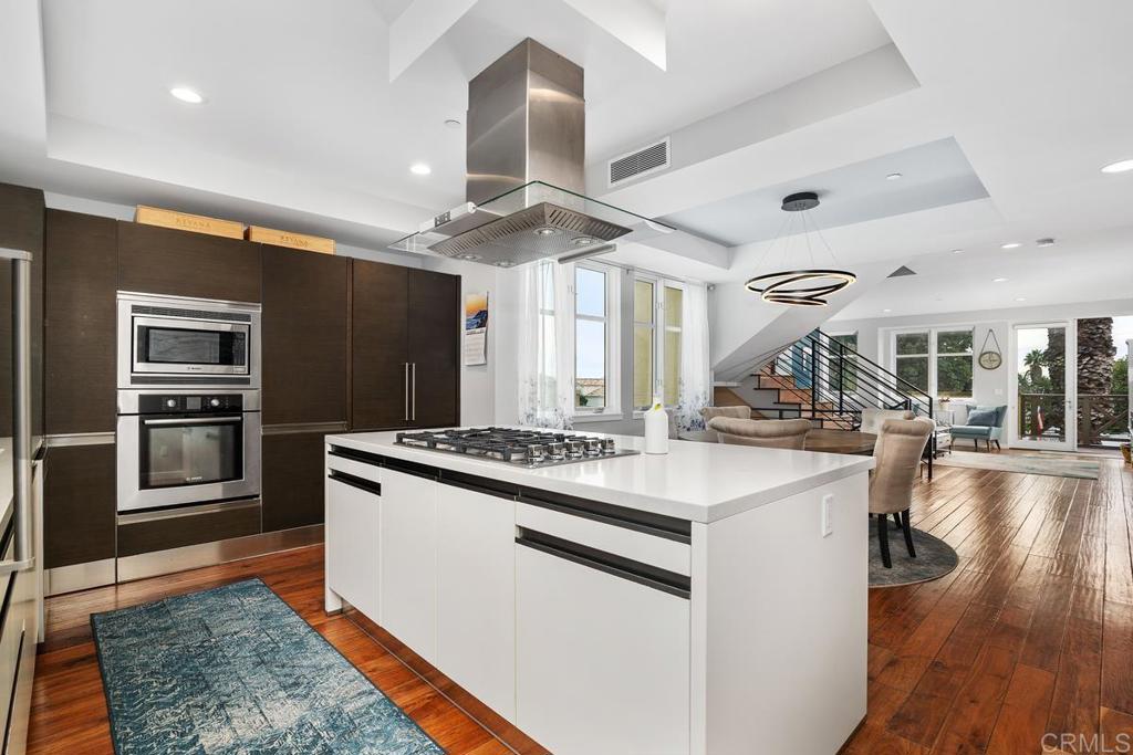 215 2nd Street, Unit 101 Encinitas, CA 92024 - Photo 18 of 47 a kitchen with stainless steel appliances granite countertop a sink stove and refrigerator