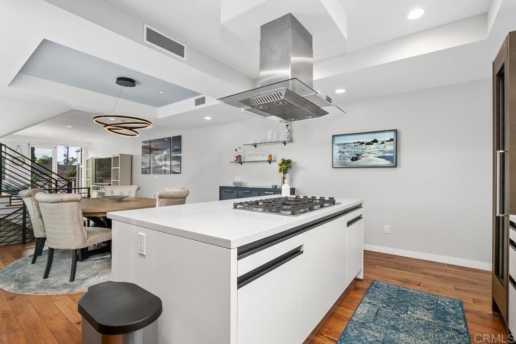 215 2nd Street, Unit 101 Encinitas, CA 92024 - Photo 19 of 47 a kitchen with a stove and a table