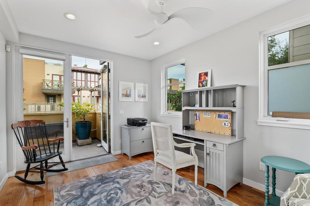215 2nd Street, Unit 101 Encinitas, CA 92024 - Photo 20 of 47 a living room with furniture a window and a flat screen tv