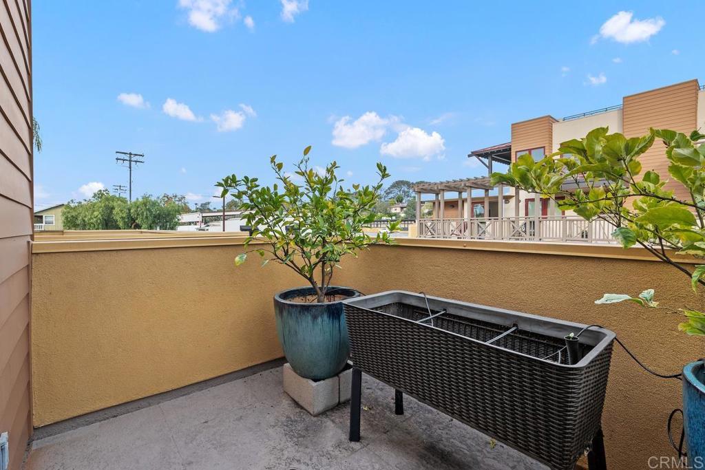 215 2nd Street, Unit 101 Encinitas, CA 92024 - Photo 21 of 47 a view of a balcony with chair and table