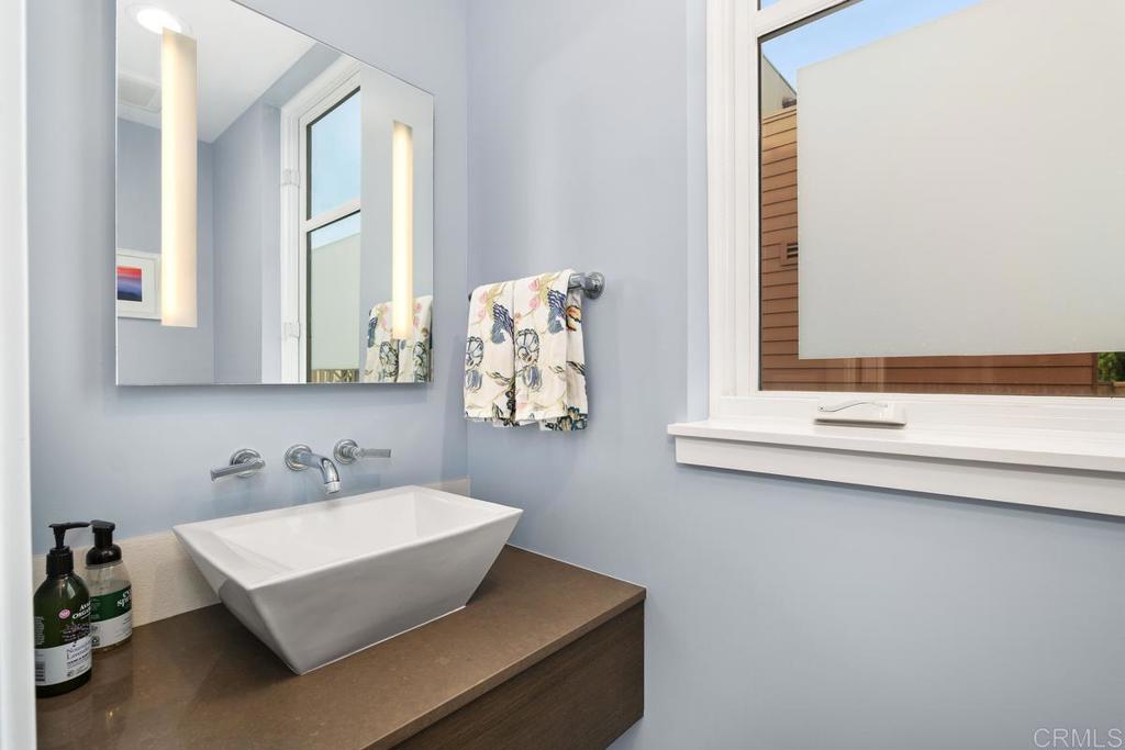 215 2nd Street, Unit 101 Encinitas, CA 92024 - Photo 23 of 47 a bathroom with a sink and a mirror