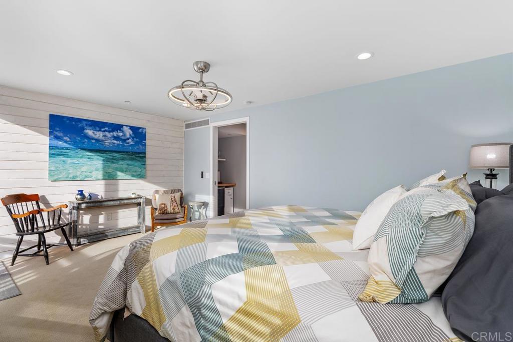 215 2nd Street, Unit 101 Encinitas, CA 92024 - Photo 25 of 47 a bedroom with bed and a chair