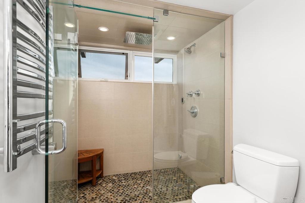 215 2nd Street, Unit 101 Encinitas, CA 92024 - Photo 30 of 47 a bathroom with a shower a toilet and a sink