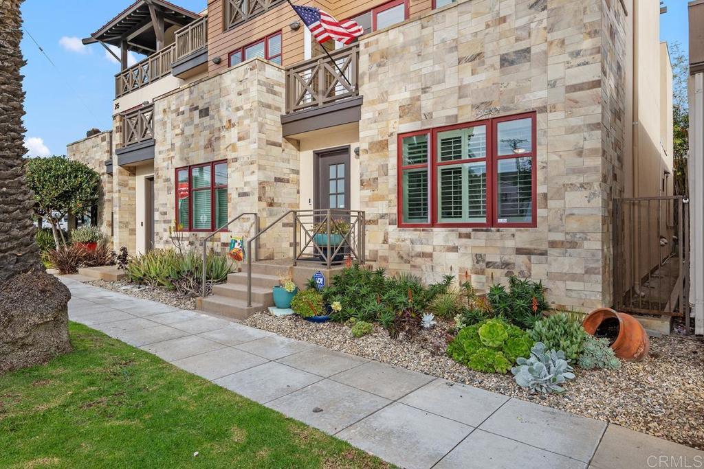 215 2nd Street, Unit 101 Encinitas, CA 92024 - Photo 3 of 47 a front view of a building with potted plants