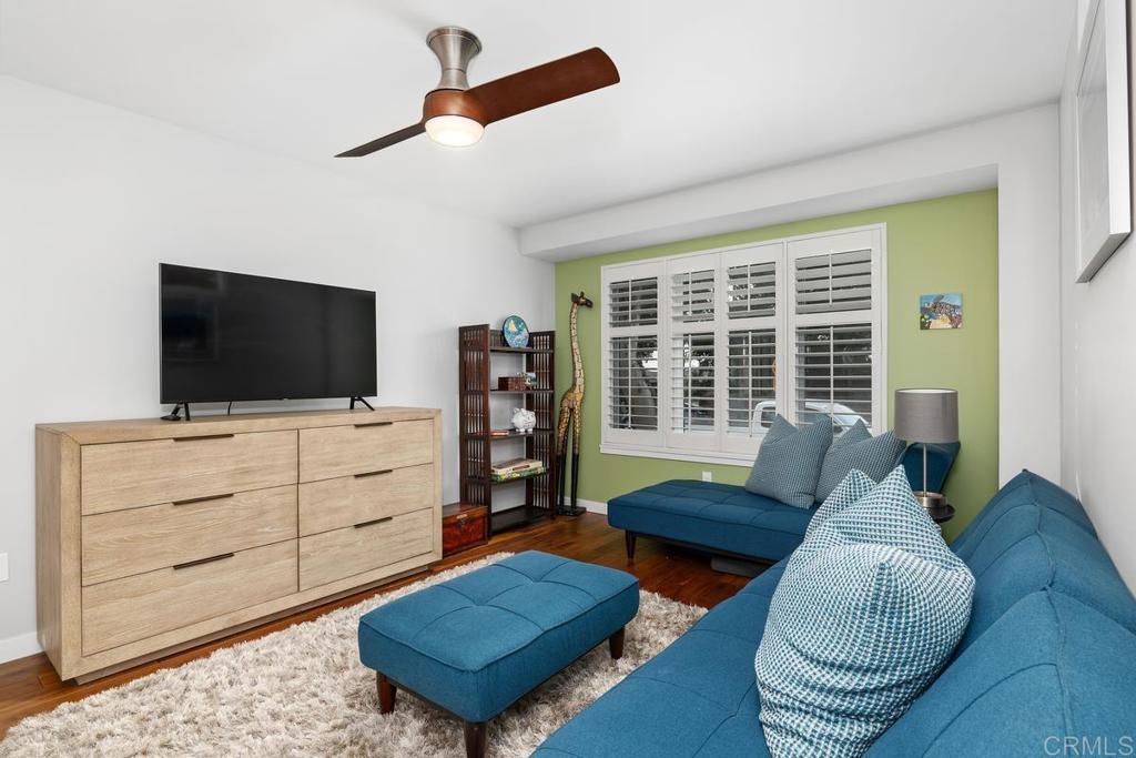 215 2nd Street, Unit 101 Encinitas, CA 92024 - Photo 36 of 47 a living room with furniture a flat screen tv and a window