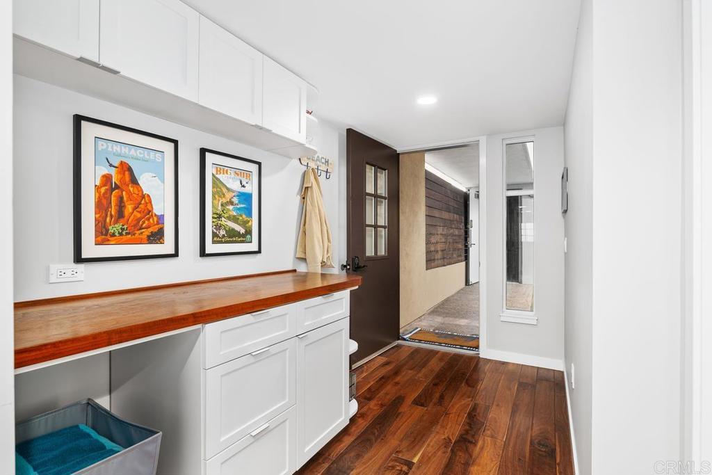 215 2nd Street, Unit 101 Encinitas, CA 92024 - Photo 38 of 47 a view of a hallway with wooden floor and windows