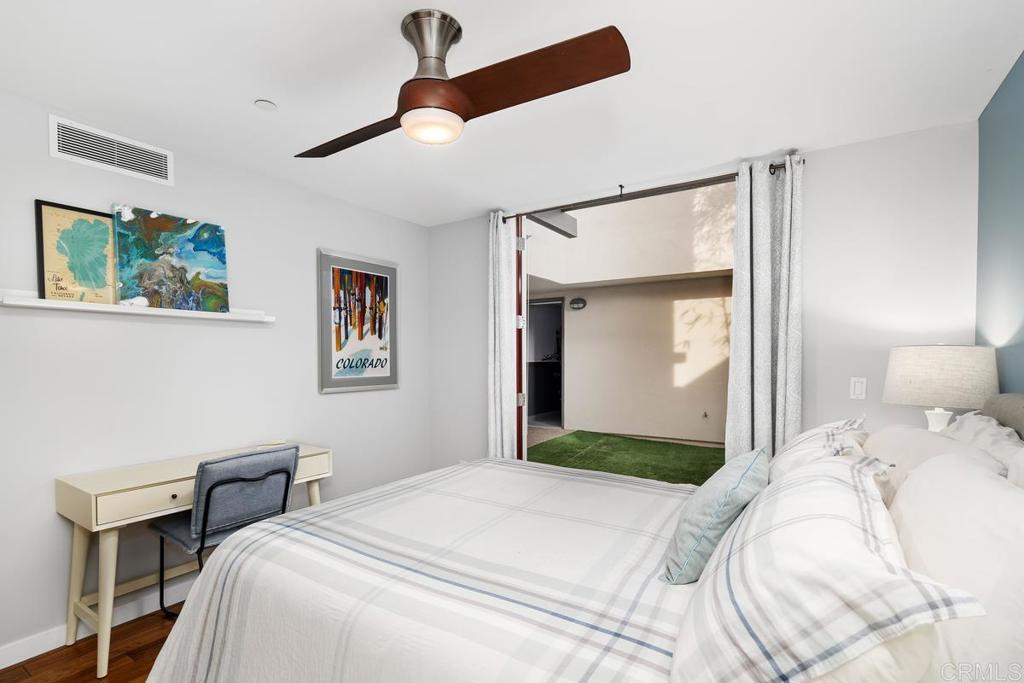 215 2nd Street, Unit 101 Encinitas, CA 92024 - Photo 40 of 47 a bedroom with a bed and a mirror