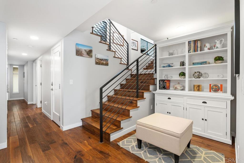 215 2nd Street, Unit 101 Encinitas, CA 92024 - Photo 8 of 47 a view of entryway with furniture and wooden floor