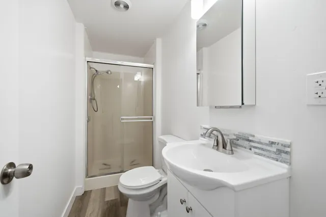 a bathroom with a sink toilet and shower