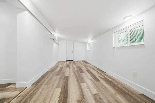 a view of a room with wooden floor and staircase
