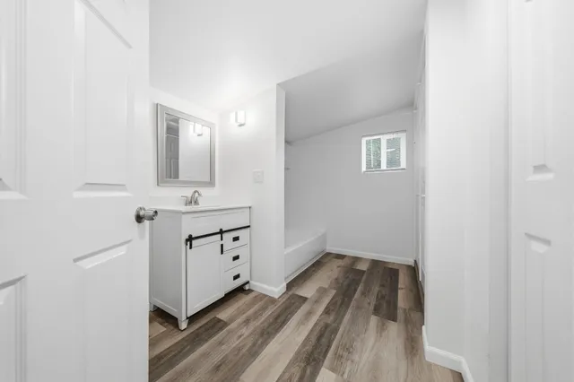 a bathroom with a sink a mirror and a toilet