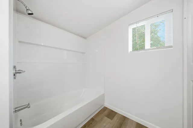 a view of bathroom with bathtub and shower